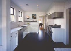 Tubular cabinet pulls copied from the stainless steel appliances unify and simplify the kitchen's design.