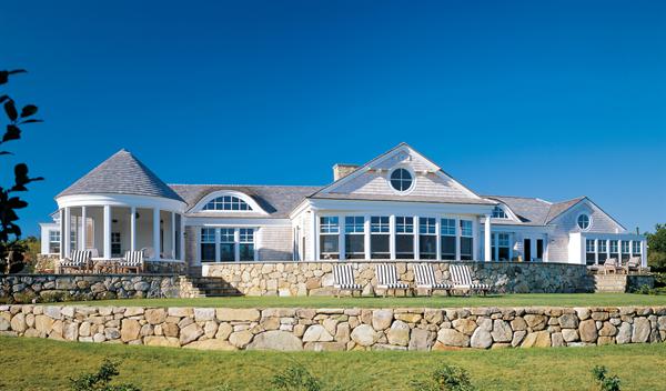 The variety of rooflines and room projections on the oceanfront elevation help make the house appear smaller than it really is.