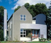 Traditional materials like stucco and clapboard siding blend well with the neighborhood. The asymmetric fenestration adds modern sensibility.