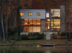 A sloped site allows the quieter, two-story front facade to give way to the more dramatic rear.