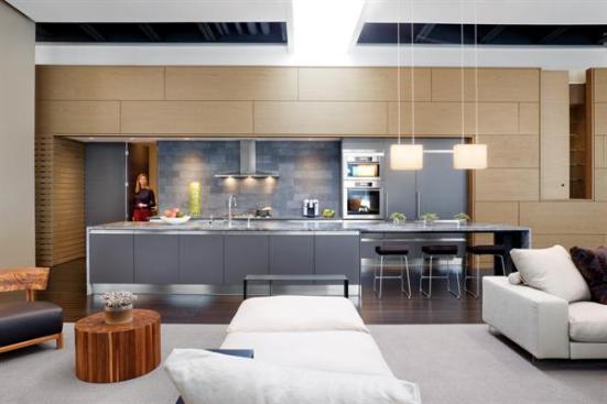 The centerpiece of a 5,000-square-foot urban loft apartment, this kitchen offers a dramatic stage for entertaining-along with discreet "backstage" access to a butler's pantry and a hidden passage to the master suite.