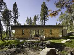 8-foot-tall windows on either side create a transparent living room at architect John Carneys Fish Creek Guest house in Wilson, Wyo.