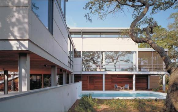 Raised by code above a potential storm tide, this riverfront home uses its perch to good advantage as a nature observatory.