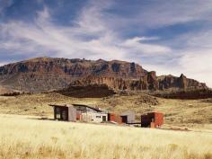 The house's silhouette echoes the forms of the surrounding landscape.