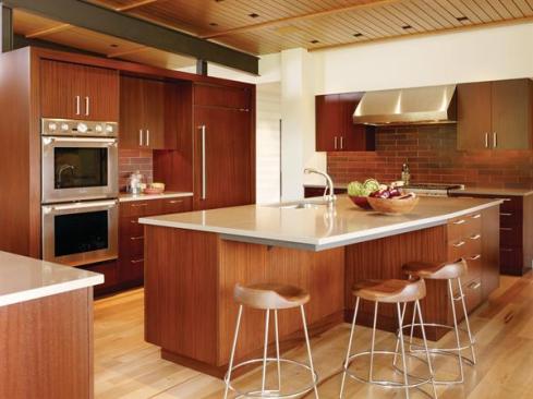 The kitchen is defined by freestanding banks of millwork. 