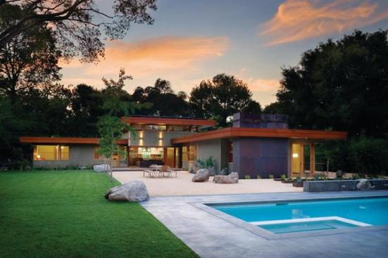 Clerestory windows facilitate passive cooling, and the homes rooftop holds both solar hot water and photovoltaic panels.