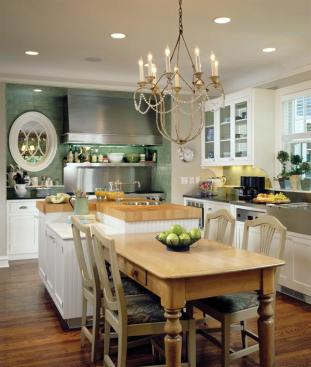 The oval window next to the stove lets light pass through the interior wall. Placement of the window also marks the center line along which the main living spaces dining, kitchen, and family are aligned.