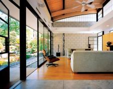 The home's oversized sliding doors, ceiling fans, and many operable windows allow for cross-breezes and natural air circulation