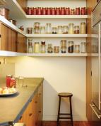 Nestling the refrigerator, storage, and pantry in the back service area opens the rest of the space to multiple uses.