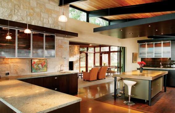 A funky island adds a little levity to the serious cooking space. Black tubular steel supports a thick concrete counter. A gunmetal gray, high-gloss fi nish on the island's base brings in the fun without detracting from the surrounding luxury specs.