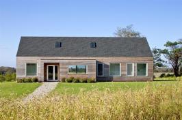 Located in a wildflower meadow, the cedar-clad gable-roofed is surrounded by native plantings and a drought-tolerant grass blend.