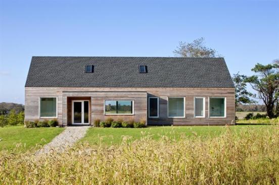 Located in a wildflower meadow, the cedar-clad gable-roofed is surrounded by native plantings and a drought-tolerant grass blend.