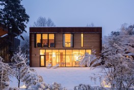 The modern addition in the snow, at dusk.