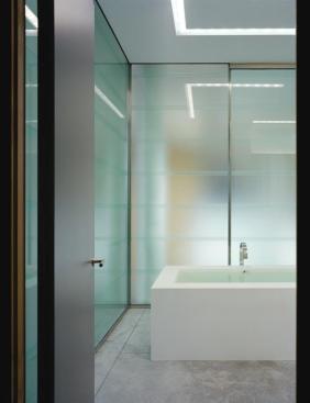 Symmetrical layers of acid-etched glass provide a measure of privacy and soften the look both inside and outside the master bath.