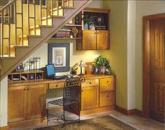 Aristokraft's clever solution turns an oddly shaped space into a streamlined, built-in workspace. Shown here is maple Winstead-style cabinetry and shelving with an autumn finish.