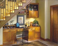 Aristokraft's clever solution turns an oddly shaped space into a streamlined, built-in workspace. Shown here is maple Winstead-style cabinetry and shelving with an autumn finish.