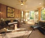 The verandah was designed for overflow party space and daily use, including a skirted swing for two. Upholstered furniture in free form shapes and leather-covered chaise lounges evoke the "Primitive Modern" design concept in the home's decor.