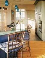 Seafoam green cabinetry, royal blue islands, and a frosty glass countertop are the perfect recipe for this award-winning custom kitchen in Kiawah Island, S.C.