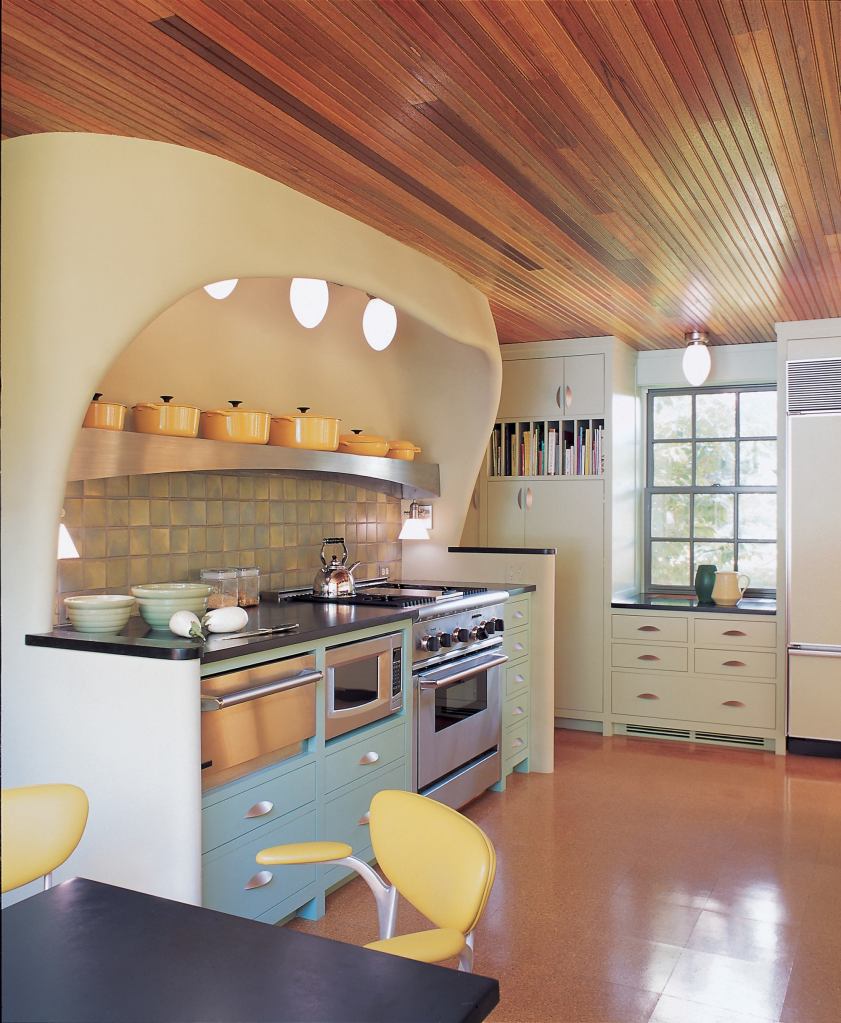 The plaster curves of the range hood reappear in the dining room mantel.
