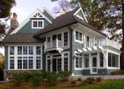 A multitude of windows and period details gives this Lake Geneva shingle-style house its quintessential cottage look.