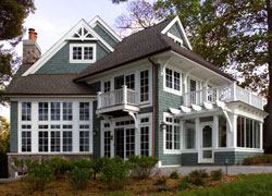 A multitude of windows and period details gives this Lake Geneva shingle-style house its quintessential cottage look.
