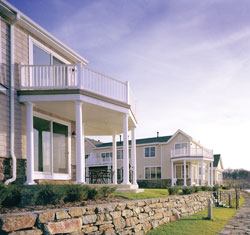 Crisp white accents, traditional shingles, and stone details give the homes at Discovery Cove a real Nantucket feel.