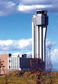 A transmitter from Proxim Corp. at the visitor's center at the Stapleton project in Denver beams up to the control tower at the old Stapleton Airport. This technology is part of the infrastructure that will help build a wireless community for 12,000 to 15,000 homes on 7.5 square miles.