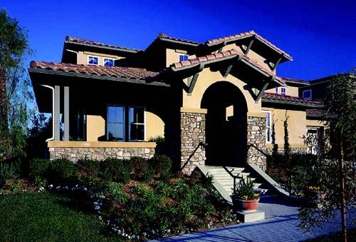 OUTDOOR INTEREST: Exterior rockwork, porches that wrap, and unusual window configurations give the homes at Auburn Lane plenty of street-side flavor.