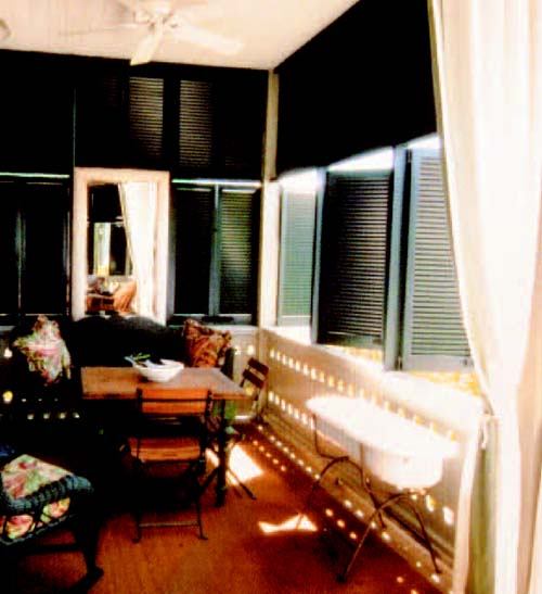 COME ON IN: The front porch sets the tone at architect Jim Strickland's Florida beach cottage, a guest-friendly house in the panhandle community of WaterColor. Operable shutters and plenty of comfortable seating turn the porch into an all-weather, outdoor living space.