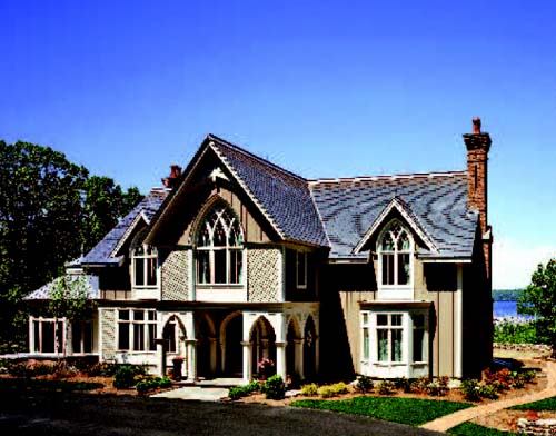 STATELY FAÇADE: Lofty lancet-arched windows, steep vaulted roofs, and other Gothic-Revival details give this house, which overlooks the Connecticut River, a proud outlook.