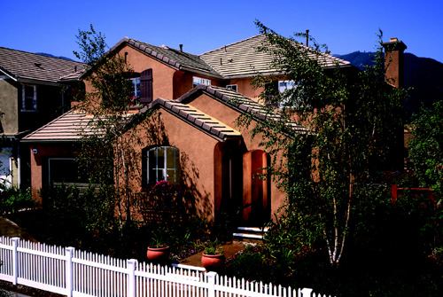 SPANISH STYLING: Plan 2, with its rich, terra-cotta–colored detailing, is the Summit's most popular model. Buyers love the entry courtyard and the office/den option at the front of the home.