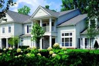 OUTWARD APPEAL: Lush landscaping frames the condominium units at Addington Corners. Exterior interest is heightened by the use of multiple windows, a mix of stone and clapboard, and a varied roofline.