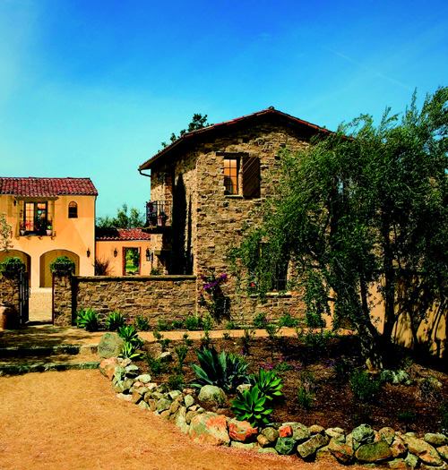 ARTFUL COMPOSITION: An antidote to big-box floor plans, Plan One, which garnered home of the year honors, is a medley of asymmetrical structures. With its clay tile roofing, iron balconies, and curved arcades, the 4,014-square-foot home evokes the region's early Spanish influences.