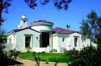 FUN IN THE SUN: Playful scroll motifs are repeated at ground level and along the roof plane.