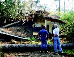 STARTING OVER: Loranger, La., builder David Reed (opposite page, left) and electrician Don Kennedy (right) inspect Kennedy's ruined house in Mandeville, La., on Sept. 13, along with State Farm insurance adjuster Jesse Curtis (center). Builders and tradesmen are as heavily affected as others in the community by storm damage. At the time of this picture, Kennedy had found an apartment and was working part-time; his destroyed home was 100% covered by insurance, including tree removal, personal belongings, and temporary living quarters. Reed, who rode out the storm at his mother's house on the family farm, was in permitting for a new 20-unit subdivision of 1,500-square-foot homes. “We know they're going to sell,” says Reed.