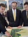 A WORKING PARTNERSHIP: Mid-Atlantic Cos.' three partners (John Lavery, vice president of sales and marketing, Roger Lebbin, and Stephen Paul) pore over a map of one of their Prince George's County, Md., subdivisions displayed in a model home.