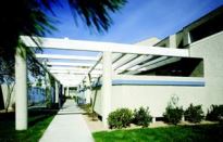 SUN SCREEN: Utilizing deeply recessed windows and a stout system of privacy walls and trellised walkways, The Arbors (above) effectively shields its townhouse owners from the legendary Las Vegas sun. Residents enjoy shaded patios, while recessed clerestory windows (rather than heat-seeking skylights) add an extra light source for the open interiors of this 1984 merit award winner.