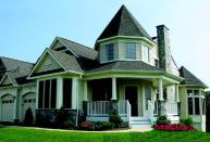 TAKE IN THE SIGHTS: Stone detailing, multiple rooflines, turrets, and porches give this attached villa extra visual interest. A two-story living room allows lots of light to reach the house's interior.