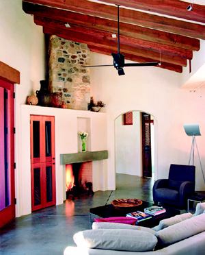 HIDE AND SEEK: A big challenge was incorporating modern conveniences into an otherwise rustic space. A flat-screen TV on a folding arm tucks into the closet to the left of the fireplace (left) when it is not in use.