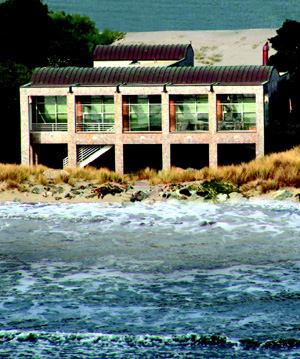 PASS THE SALT: Prefinished, aluminum-frame windows (above) are primed with an epoxy paint finish to thwart the ocean air. All exterior handrails and stairs are galvanized steel. The standing-seam copper roof will eventually oxidize to green.