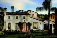 LOCAL FLAVOR: Barrel-tile roofs, ornate window grilles, cupola-topped chimneys, and decorative tile surrounds reflect the region's Spanish influences.