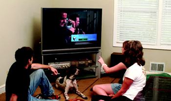 LAUNDRY BREAK: The Spencer family of Decatur, Ga., views a pop-up Laundry Time message on  their TV while watching a favorite program. The message stays on the screen  for 15 to 30 seconds.