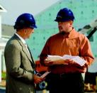 EFFICIENCY EXPORT: Bob Kehlor, C.P. Morgan's executive vice president of housing (left) talks  with John Nichols, the builder's director of construction in Charlotte, N.C., who  applies supply-chain management techniques that are successful for the  builder in its Indianapolis base.