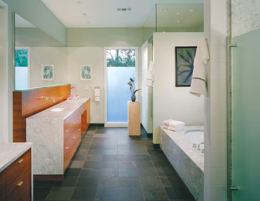 Fossilized Italian marble with a dense pattern "that simulates fabric" helps overturn the perception of stone as a cold material, says architect Shane Cook. Draping the marble over the sides not only protects vertical surfaces from splashes, but abstractly expresses the idea of a hanging towel.