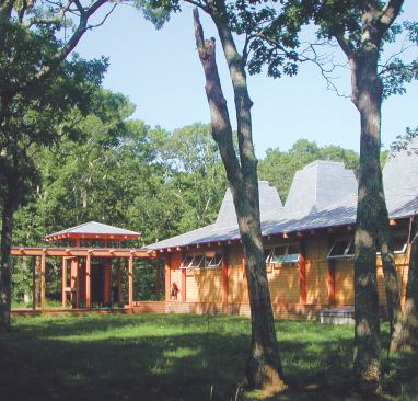 The shower's exposed roof system matches that of the house, visually tying the two structures together.