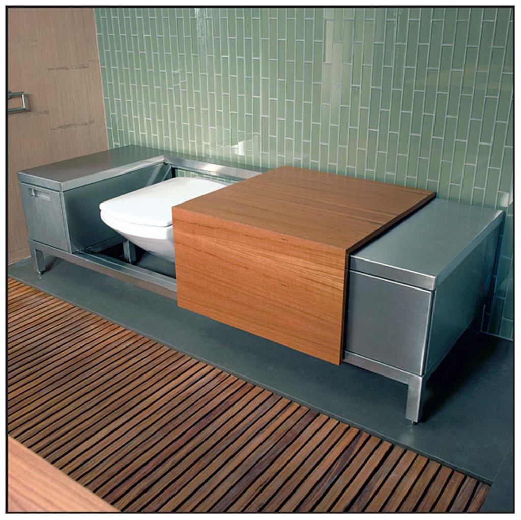 Adams’ geometric design incorporates spartan details, including heavy mullions in the glass wall behind the vanity (left) and a window on the opposite wall (above) that was cut to match the size and shape of the wall sections. Cantilevered shelves, horizontal-grain cabinetry, and a long, low toilet bench (far left) complete the look.