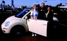 CAR CRAZY: Katherine Elder (left) is one of three lucky winners of a VW Beetle convertible. The  cars were raffled off by The Corky McMillin Cos. this past summer  to generate sales traffic in six of the builder's San Diego communities.