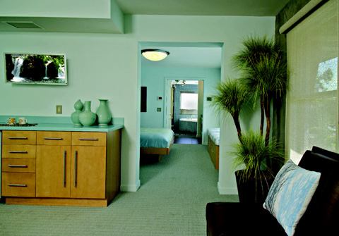 Like a tree house set in the limbs of a mature oak in the neighborhood, the master suite that occupies the entire second level of the home is a true getaway. The difference, of course, is that the space is much more luxuriously appointed in its finishes and is zoned for several specific activities. The lounge, for instance, is for reading, relaxation, conversation, and television viewing, or it could easily serve as a nursery. Equipped with a coffee bar, it sits in the southwest corner to gain the most natural light and views of Lake Eola—which is even more visible once the owners step out to a private balcony that extends over the home's entry porch.