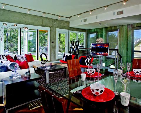 The architect used what was left in terms of the home's allowable height to blow the third level to a 10-foot ceiling, making this space the most loft-like of the three living areas. It also has the advantage of mostly unencumbered natural light, which the design leverages through extensive windows on opposite elevations and an accordion-style patio door out to the balcony.