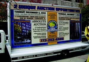 STREET MARKETING: Aggressive marketing, such as this rolling billboard, is common  before a real estate auction.